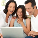 Student and parent applying for FAFSA on a laptop at home