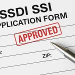 Close-up of a disability benefits application form marked “Approved” for SSDI/SSI financial aid in 2025